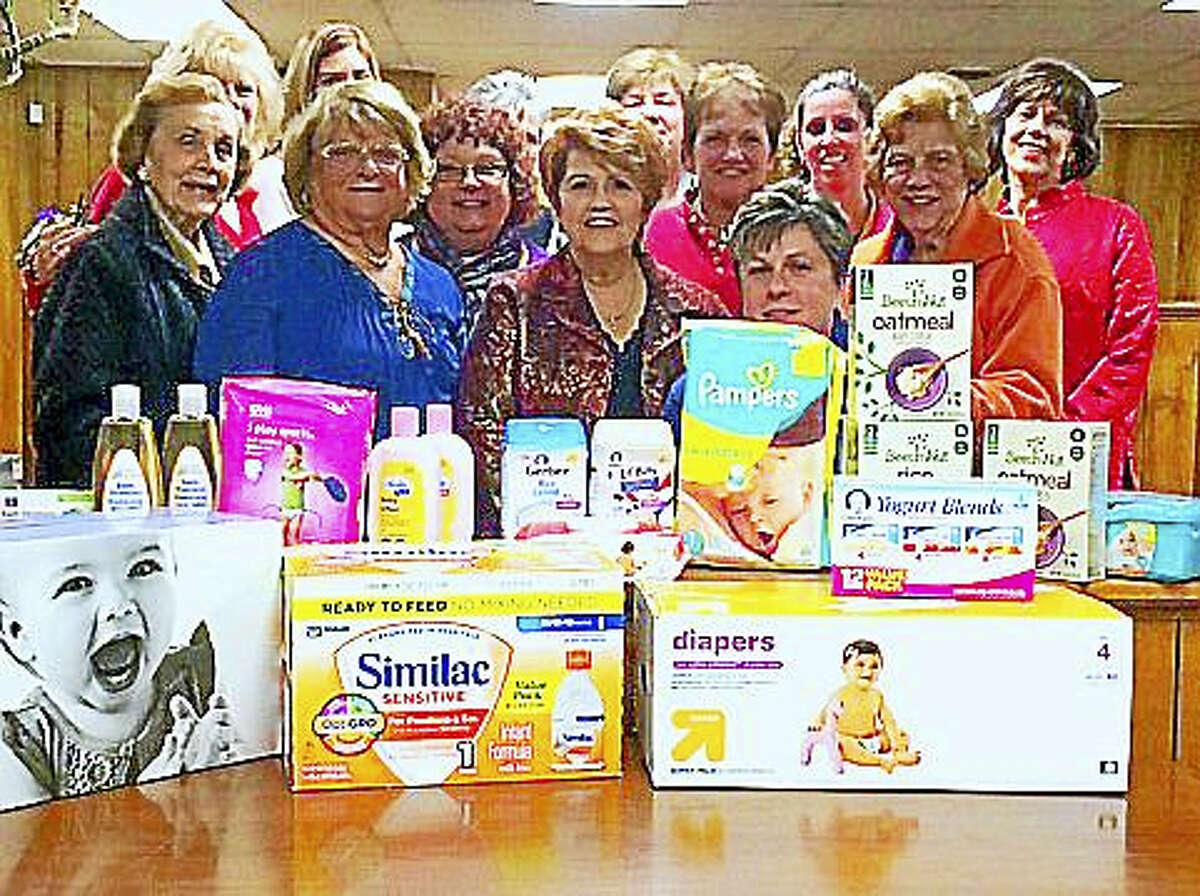 Members of Altrusa International Central Connecticut pose with donations of diapers, food and care items for families with children under three.