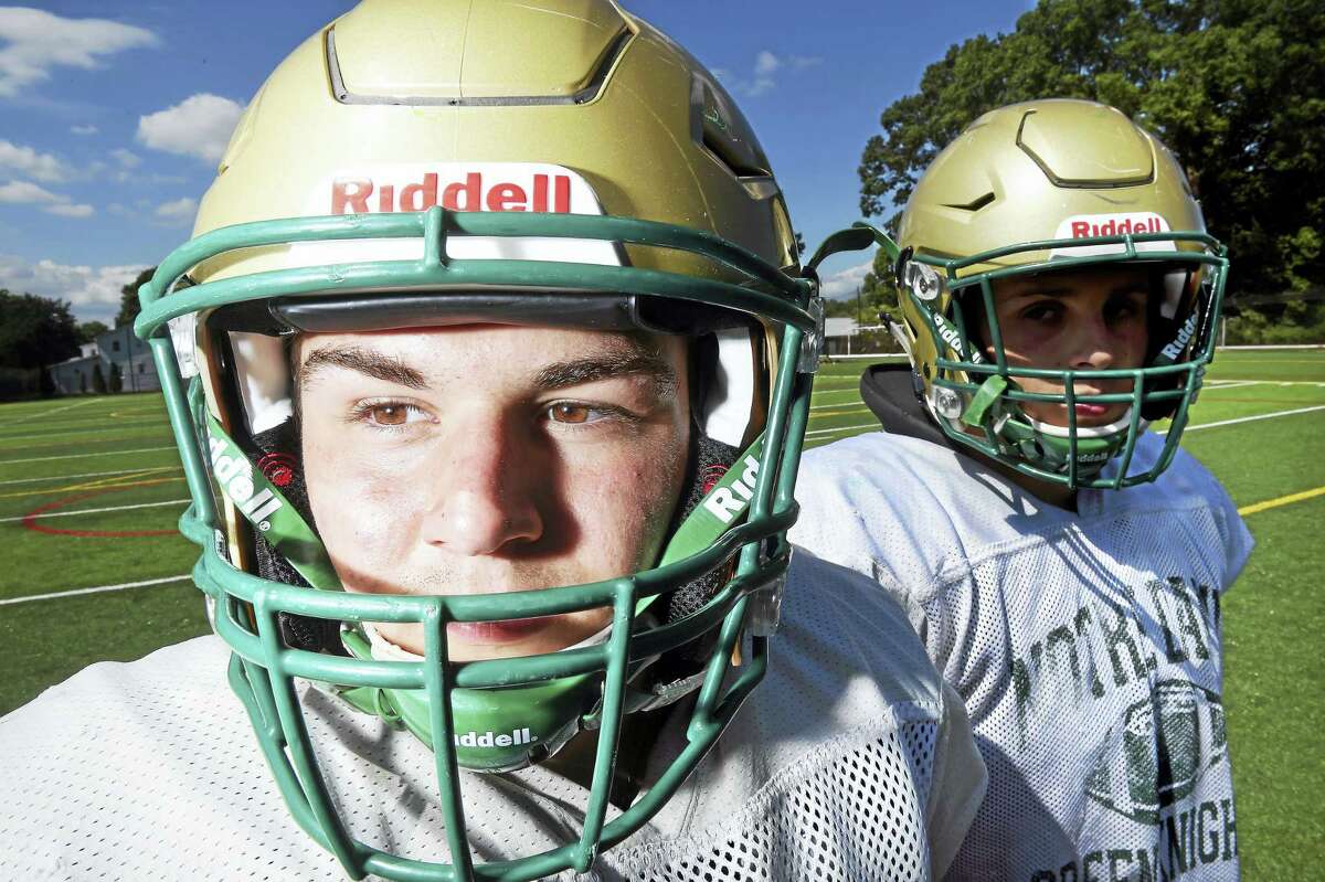 Notre Dame linebackers Tristan Andrzejewski, left, Frank Longley are photographed wearing Riddell Flex helmets outfitted with the Reddell Insite sensor system inside.