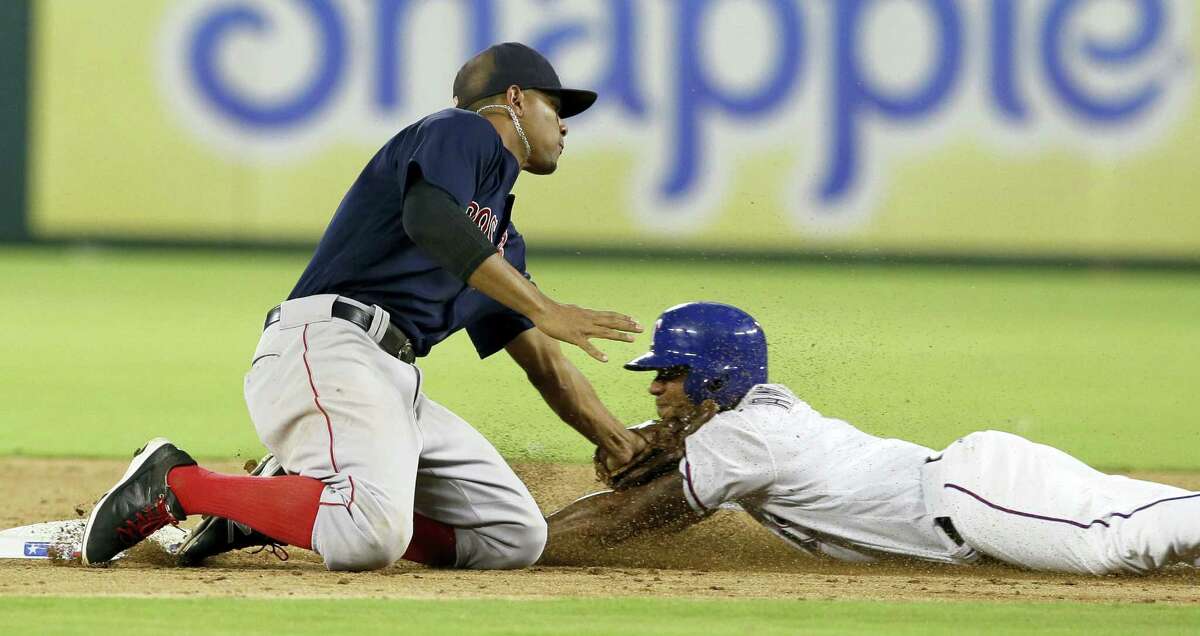 Elvis Andrus, right, is caught stealing second base as Red Sox shortstop Xander Bogaerts applies the tag in the fourth inning on Friday.