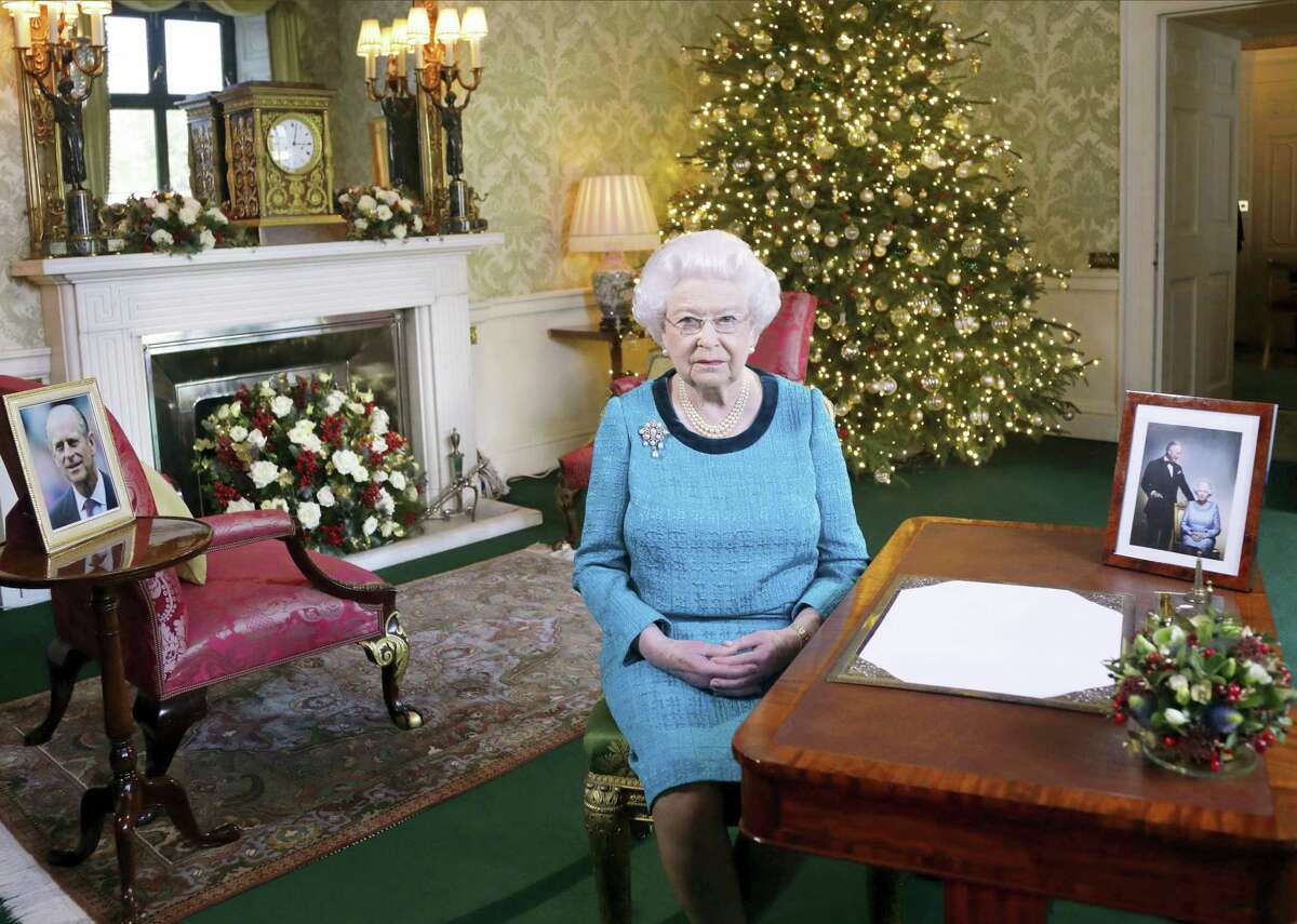 In this photo released Dec. 25, 2016 Britain’s Queen Elizabeth II poses for a photo, sitting at a desk in the Regency Room of Buckingham Palace in London, after recording her traditional Christmas Day broadcast to the Commonwealth. Queen Elizabeth prerecords her traditional Christmas Day festive speech to be broadcast to the British Commonwealth nations on Christmas Day.