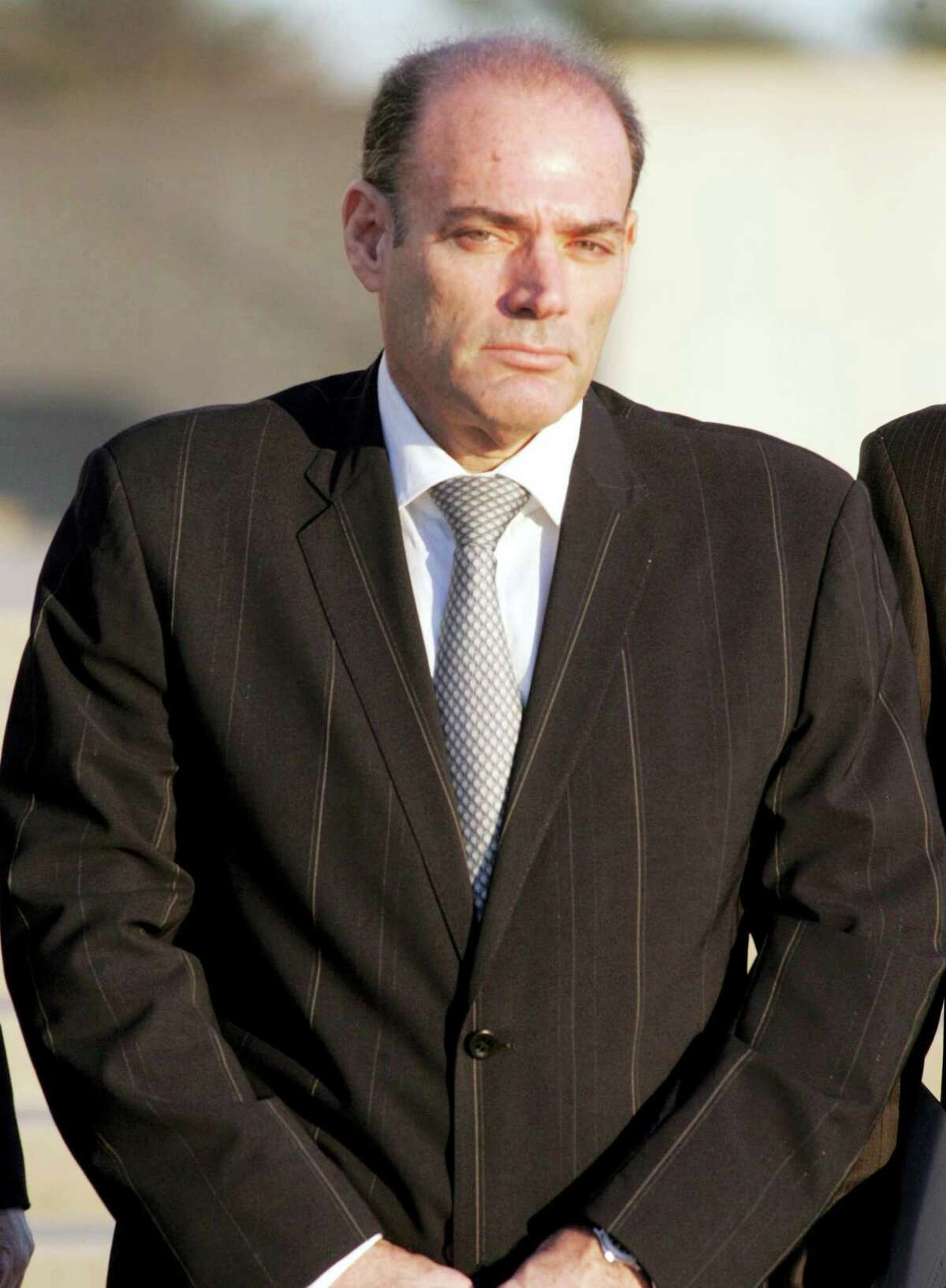 David Brooks leaves the federal courthouse in Central Islip, N.Y. in 2008. Brooks, the founder of America’s leading supplier of body armor to the U.S. military, died Thursday in prison while serving a 17-year sentence for running a massive stock fraud scheme. He was 61. Newsday, Howard Schnapp — AP File Photo