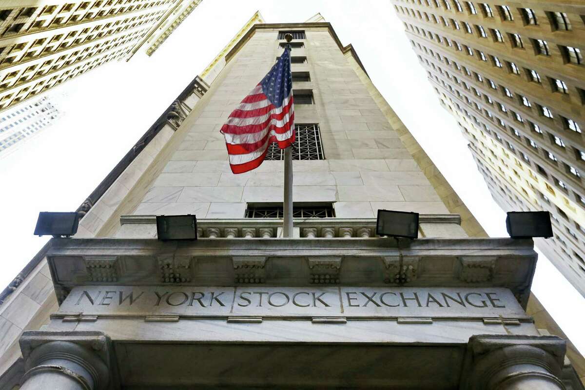 In this Friday file photo, the American flag flies above the Wall Street entrance to the New York Stock Exchange.