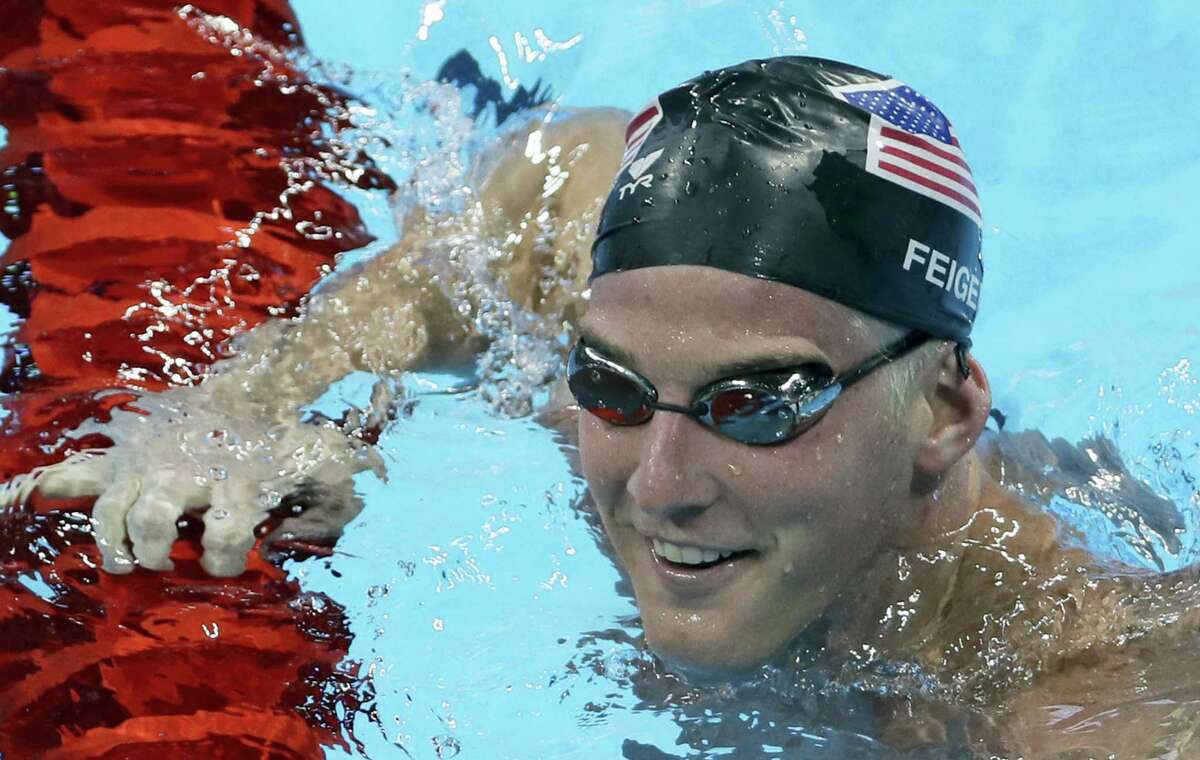 In this Aug. 2, 2016 photo, U.S. swimmer James Feigen smiles during a swimming training session prior to the 2016 Summer Olympics in Rio de Janeiro, Brazil.