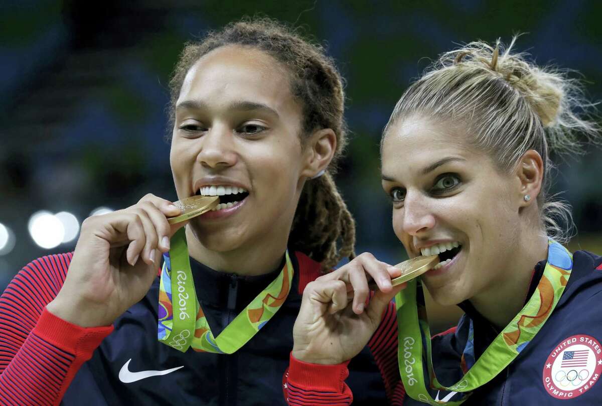 United States’ Brittney Griner, left, and Elena Delle Donne, right, celebrate with their gold medals after their win in a women’s basketball game against Spain at the 2016 Summer Olympics in Rio de Janeiro, Brazil on Aug. 20, 2016.