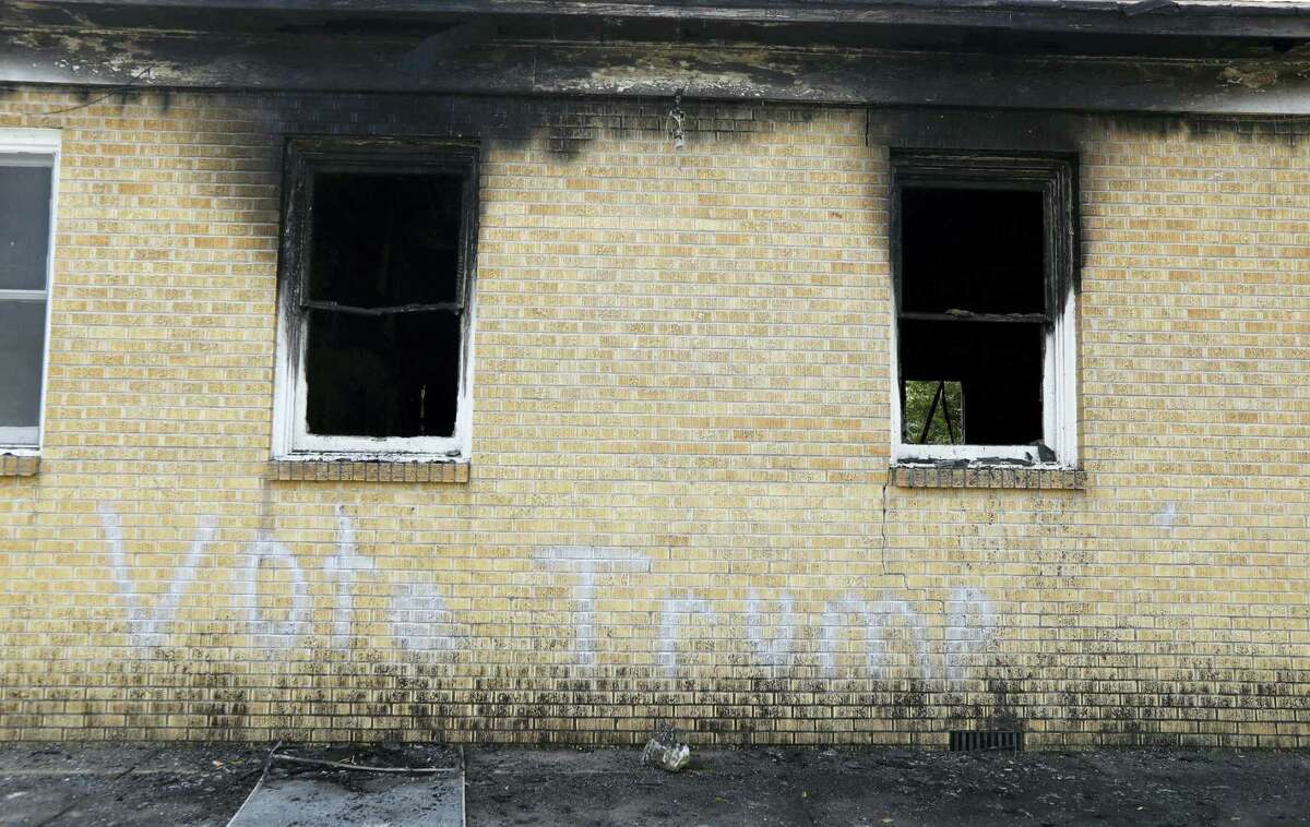 “Vote Trump” is spray painted on the side of the fire damaged Hopewell M.B. Baptist Church in Greenville, Miss. Mississippi authorities arrested a McClinton Wednesday in the burning of an African-American church that was also spray-painted with the words “Vote Trump.”