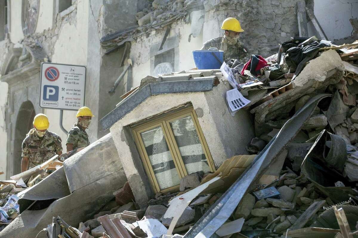 Soldiers search amid rubble of a collapsed house following an earthquake in Amatrice, central Italy, Wednesday, Aug. 24, 2016. A strong earthquake in central Italy reduced three towns to rubble as people slept early Wednesday, with reports that as many as 50 people were killed and hundreds injured as rescue crews raced to dig out survivors.
