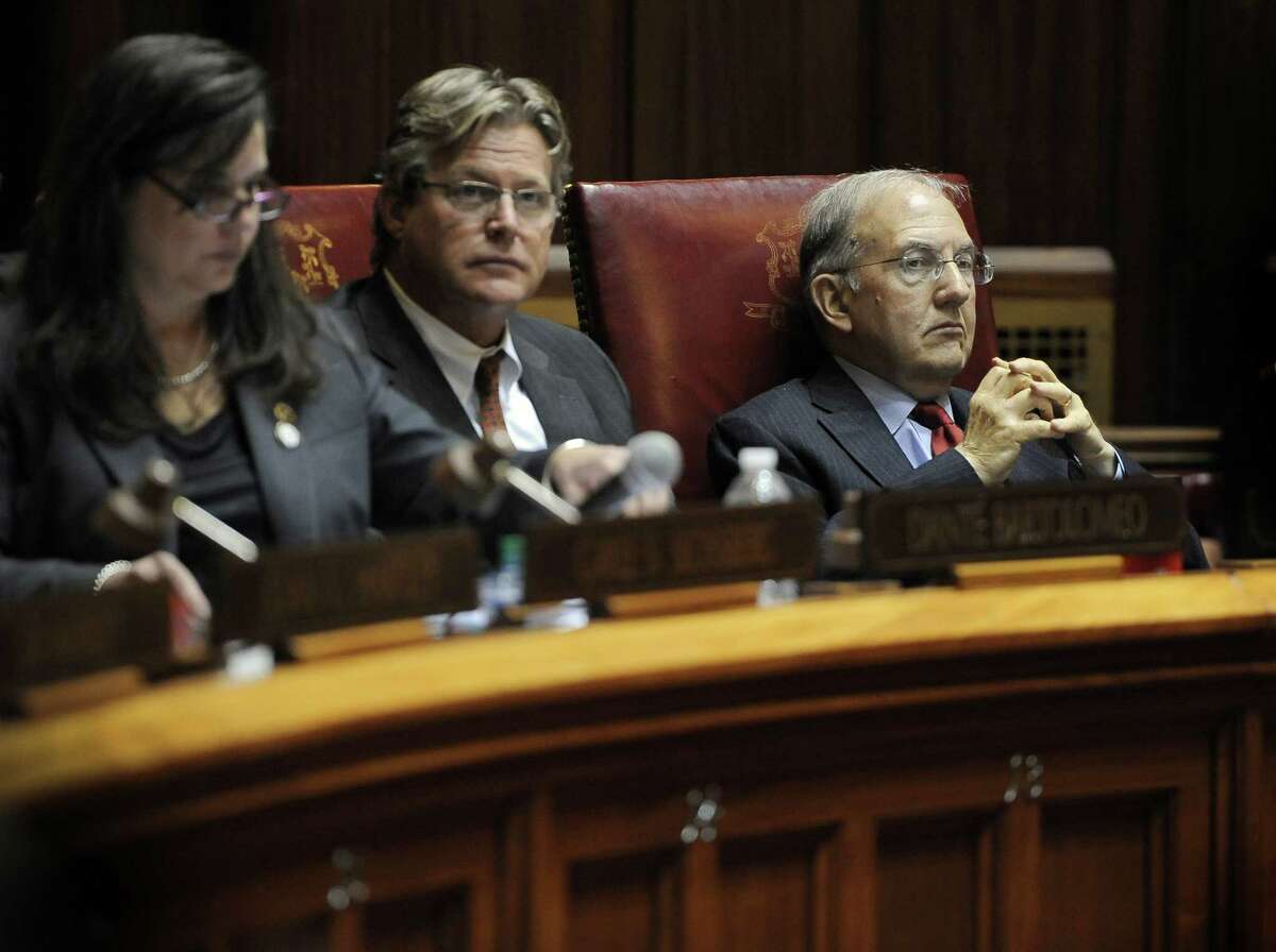Senate President Martin Looney, right, listens in the Senate during a special session on a plan to close a projected $350 million budget deficit in the current fiscal year, at the state Capitol, Tuesday, Dec. 8, 2015, in Hartford, Conn.