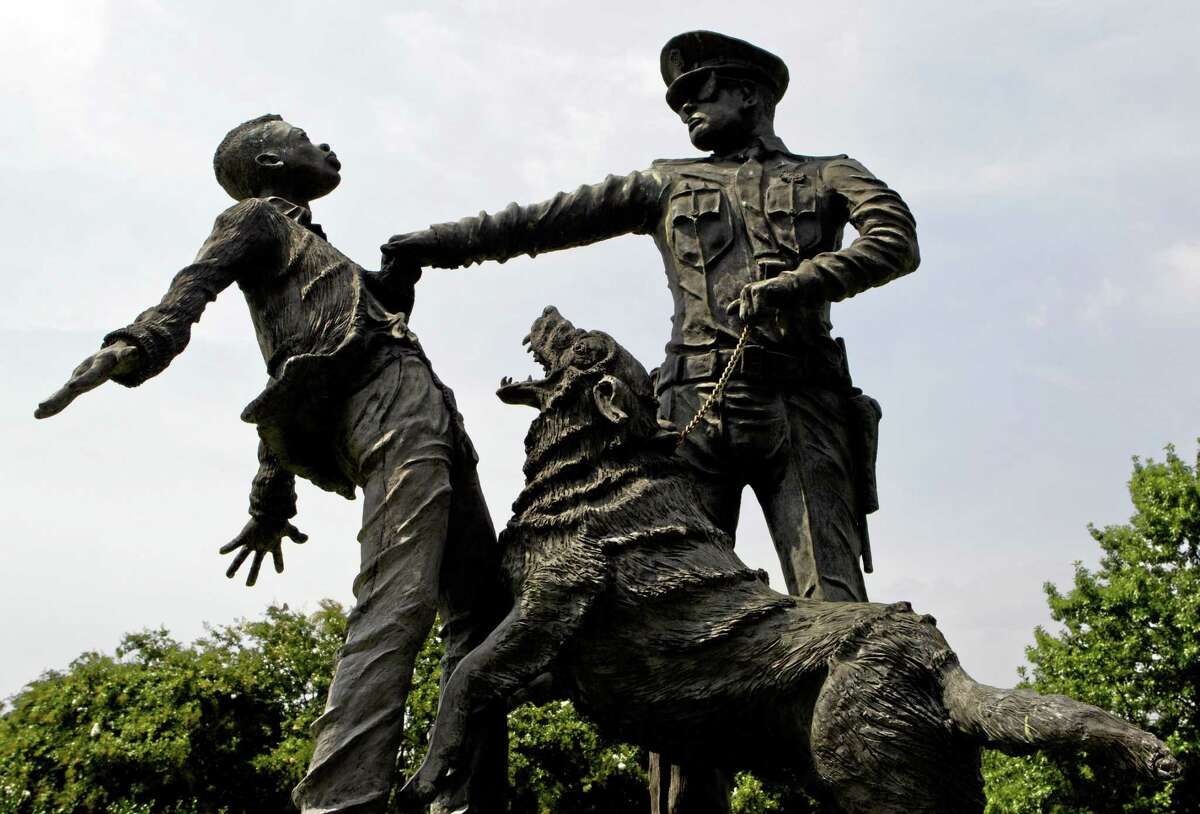 A young protester confronted by a police officer and a snarling police dog is depicted in a sculpture in Kelly Ingram Park in Birmingham, Ala.