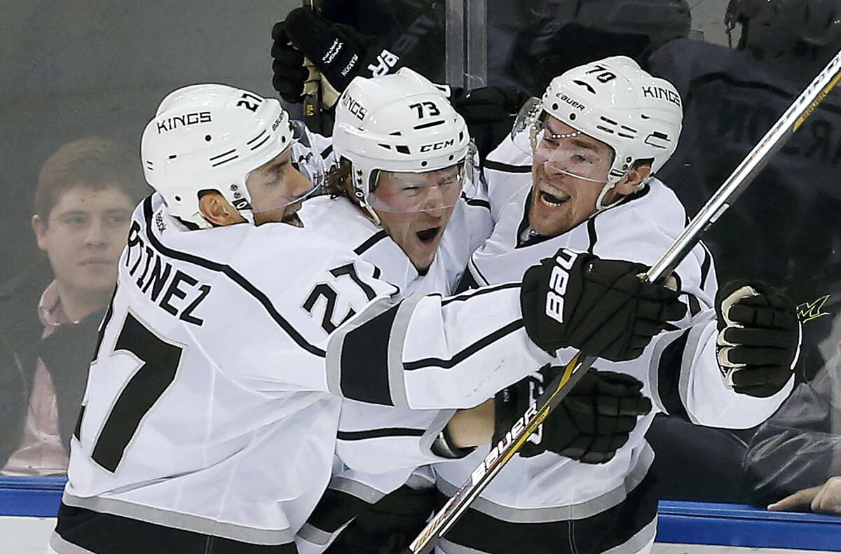 Los Angeles Kings left wing Tanner Pearson (70) celebrates with center Tyler Toffoli (73) and defenseman Alec Martinez (27) after scoring against the New York Rangers in overtime Friday in New York. The Kings won 5-4.