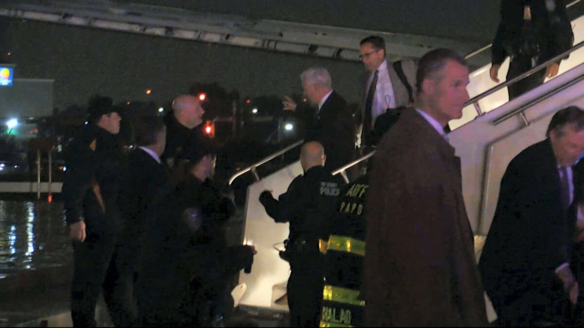 Republican presidential candidate Indiana Gov. Mike Pence walks down the steps of his campaign plane at New York’s LaGuardia Airport after it slide off the runway while landing on Thursday, Oct. 27, 2016.