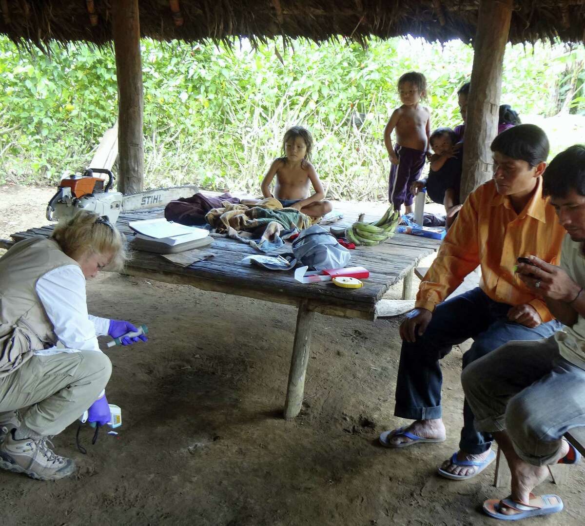 In this photo provided by Science Advances shows microbiologist Maria Gloria Dominguez-Bello, collecting temperature information of the floor at one of the Checherta huts. Whether it’s a jungle hut or a high-rise apartment, your home is covered in bacteria, and new research from the Amazon suggests city dwellers might want to open a window.