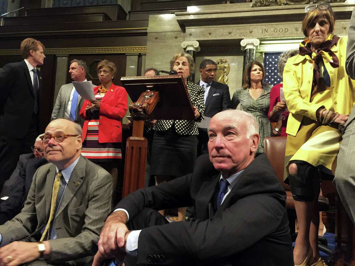 This photo provided by U.S. Rep. Chellie Pingree, D-Maine, shows Democrat members of Congress, including, front row, from left, Rep. Steve Cohen, D-Tenn., Rep. Joe Courtney, D-Conn., and Rep. Rosa DeLauro, D-Conn., participate in sit-down protest seeking a vote on gun control measures Wednesday on the floor of the House on Capitol Hill in Washington.