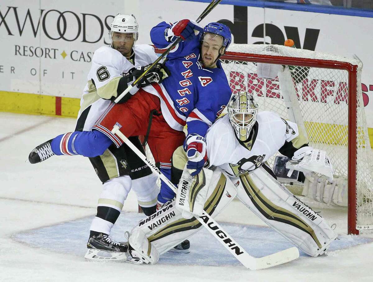 The Penguins’ Trevor Daley (6) and Matt Murray (30) defend the goal as the Rangers’ Derek Stepan fights for position during the third period on Tuesday.