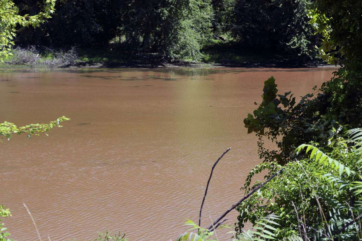 A view from Route 9 in Cromwell near Wilcox Island where the Connecticut River waters turned a rust brown Monday after heavy rains overnight sent sludge into the water from the Mattabesset River upstream. The natural phenomena is unrelated to the fire at the sewage treatment plant early Monday.
