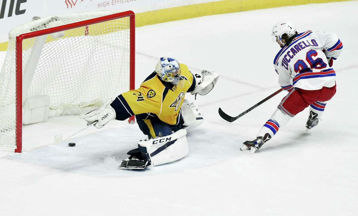 New York Rangers right wing Mats Zuccarello (36), of Norway, seals a victory with a goal against Nashville Predators goalie Juuse Saros (74), of Finland, during the shootout period of an NHL hockey game Saturday, Dec. 17, 2016 in Nashville, Tenn.