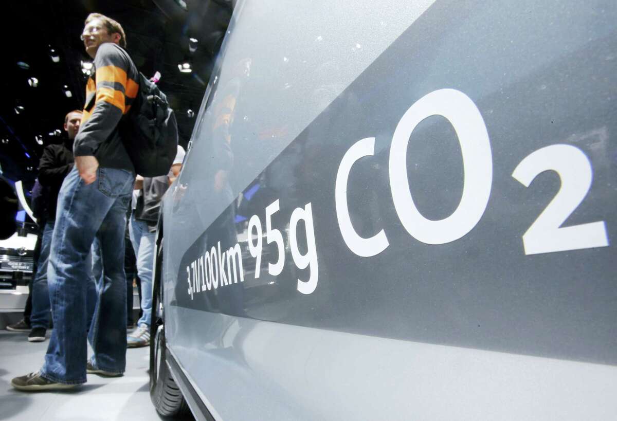 In this Sept. 22, 2015, file photo, the amount of carbon dioxide emissions is written on a Volkswagen Passat Diesel at the Frankfurt Car Show in Frankfurt, Germany. A federal judge in San Francisco has decided to approve a nearly $15 billion deal over Volkswagen’s emissions cheating scandal that gives most affected car owners the option of having the company buy back their vehicles. U.S. District Judge Charles Breyer had said last week that he was strongly inclined to give the deal final approval and would issue a ruling by Tuesday, Oct. 25, 2016.
