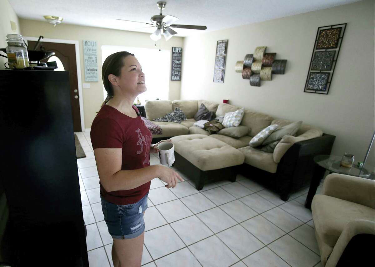 In this April 14, 2016 photo, renter Nicole Caverlyat gets settled at her home in the Piedmont Park neighborhood in Apopka, Fla., a former agricultural hub now crowded with housing developments. Where one in 10 homes was once a rental, now more than a third are. Caverlyat’s home was purchased by an investment group in January and then put on the rental market.