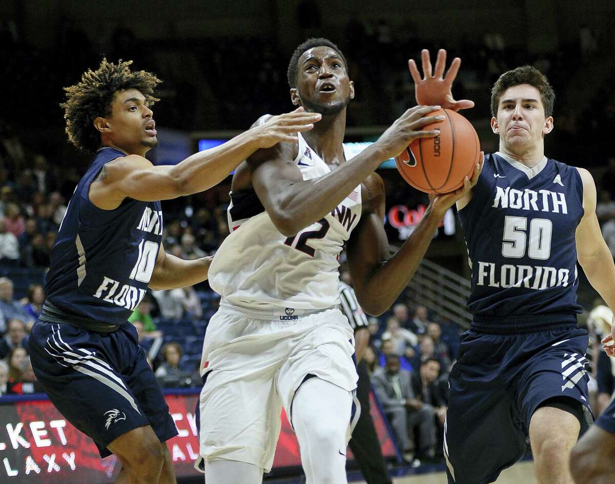 UConn’s Kentan Facey drives between a pair of North Florida defenders during Saturday’s game.