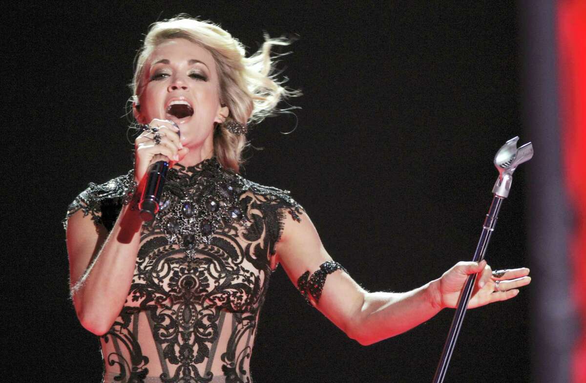 In this June 8, 2016 photo, Carrie Underwood performs “Church Bells” at the CMT Music Awards in Nashville, Tenn. Underwood will be singing a new theme song, “Oh, Sunday Night,” during the first game telecast on Sept. 11 between the New England Patriots and the Arizona Cardinals.