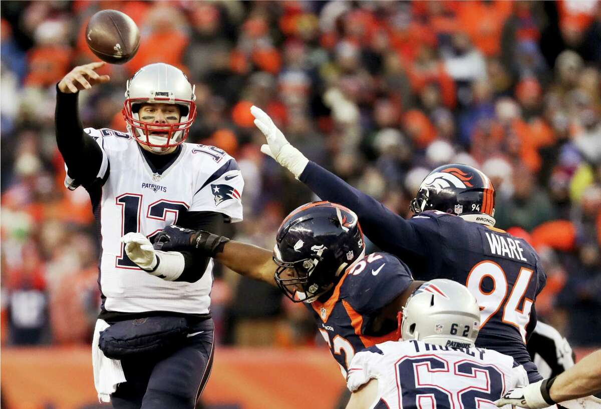 Patriots quarterback Tom Brady throws under pressure against the Broncos on Sunday.
