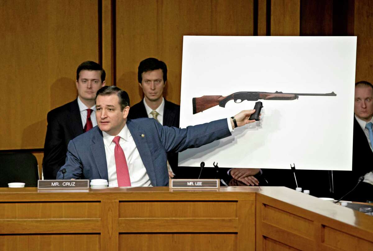 Senate Judiciary Committee member, then-freshman Sen. Ted Cruz, R-Texas uses a life size photo of a Remington 750, a popular hunting rifle, to make a point about the proposed ban on certain kinds of guns, during the Senate Judiciary Committee hearing Jan. 30, 2013 on what lawmakers should do to curb gun violence in the wake a shooting rampage at that killed 20 schoolchildren in Newtown, Conn.