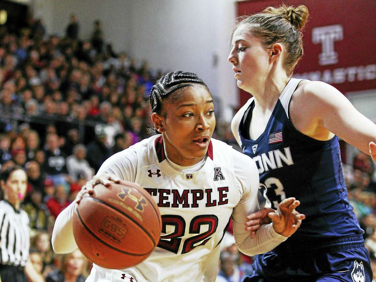 Temple’s Tanaya Atkinson, left, drives to the basket against UConn’s Katie Lou Samuelson during a game last season.