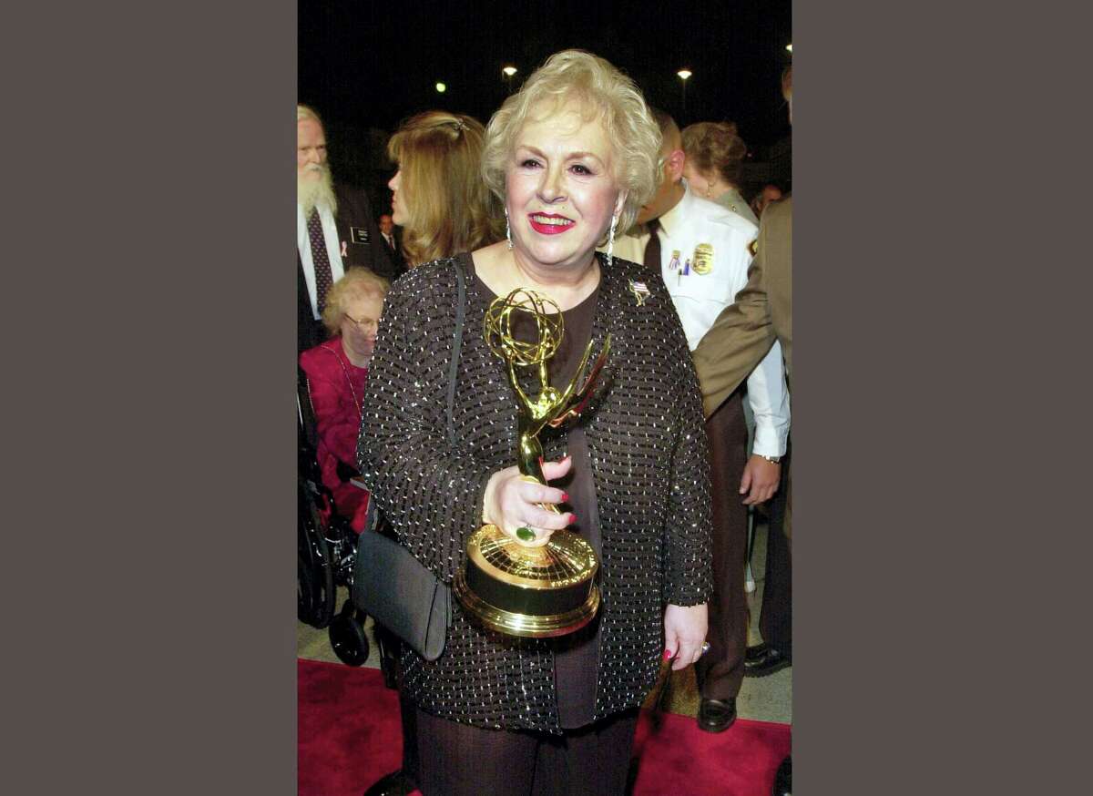 FILE - In this Nov. 4, 2001 file photo, Doris Roberts holds her Emmy for outstanding supporting actress in a comedy series for her work on "Everybody Loves Raymond" following the 53rd annual Primetime Emmy Awards in Los Angeles. Family spokeswoman said Monday, April 18, 2016, that Roberts died overnight Sunday in her sleep in Los Angeles. She was 90. (AP Photo/Kim D. Johnson, File)