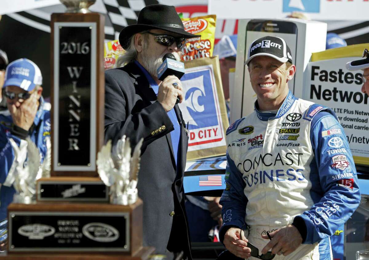 Carl Edwards, right, smiles as he’s interviewed by track announcer Tom Taylor after winning in Bristol, Tenn., on Sunday.