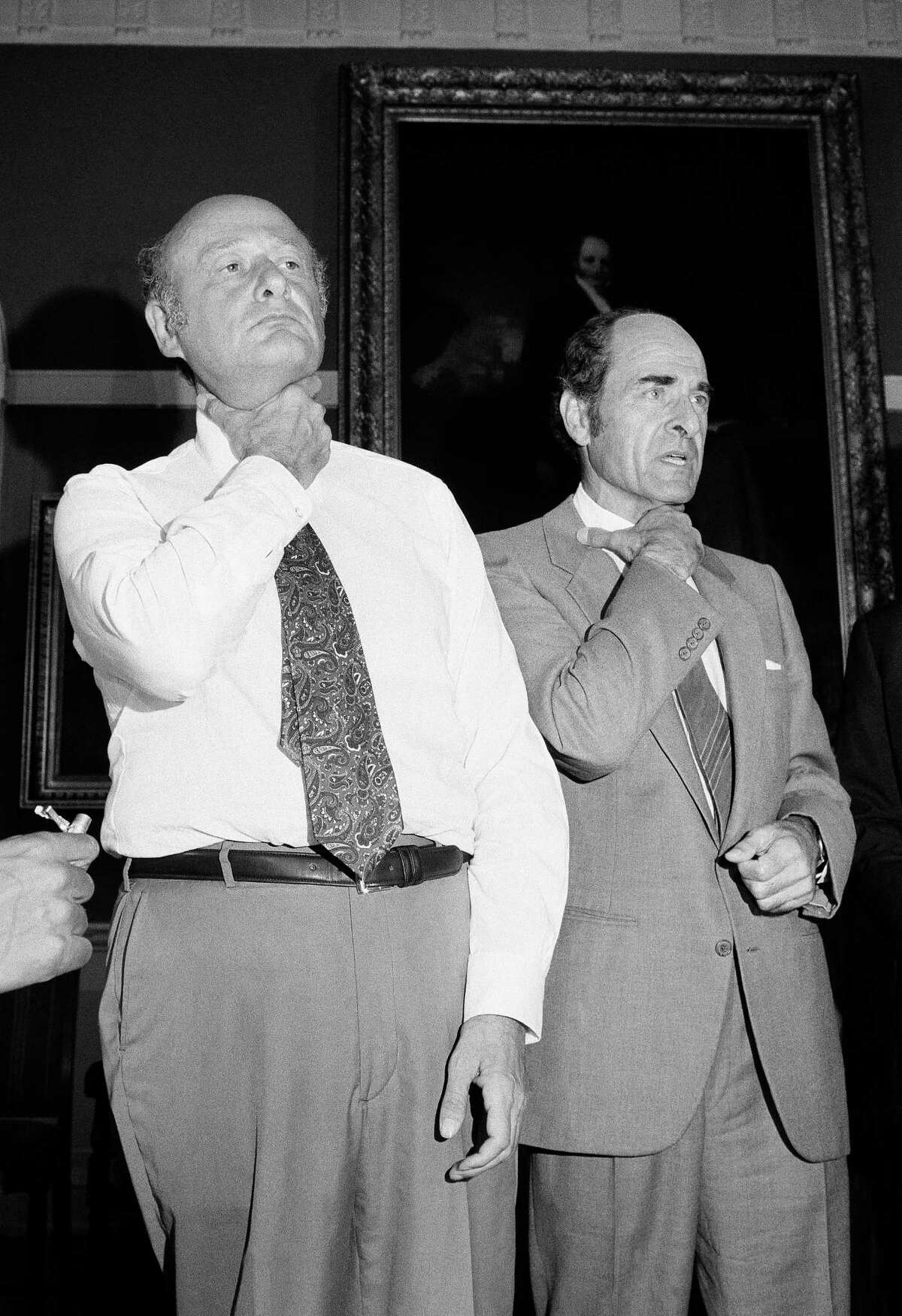 Dr. Henry Heimlich, right, and Mayor Edward Koch demonstrate how a chocking victim should signal for help at New York’s City Hall during Heimlich’s discussion of his Heimlich Maneuver.