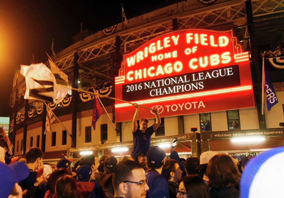 Chicago Cubs fans celebrate outside Wrigley Field on Saturday night.