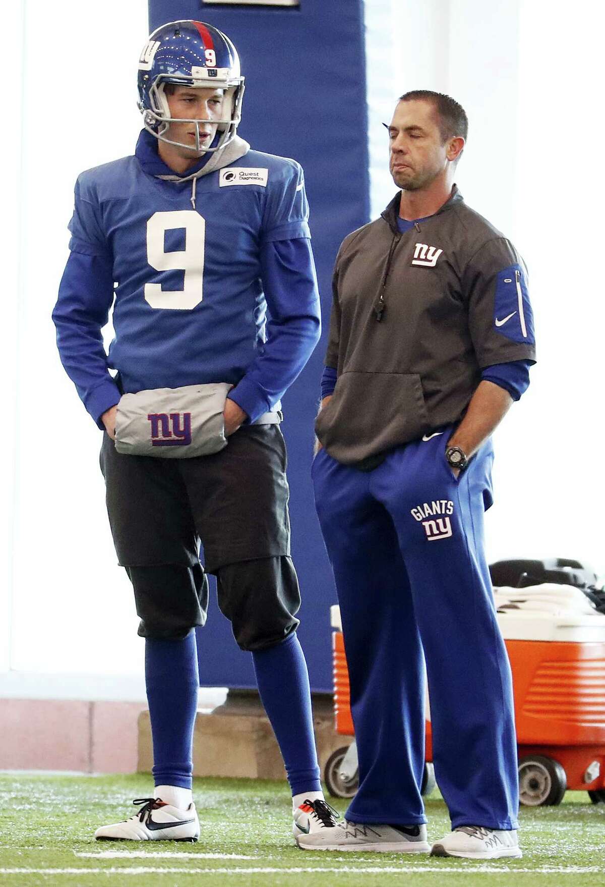 Giants punter Brad Wing (9) talks to a coach during a recent practice.