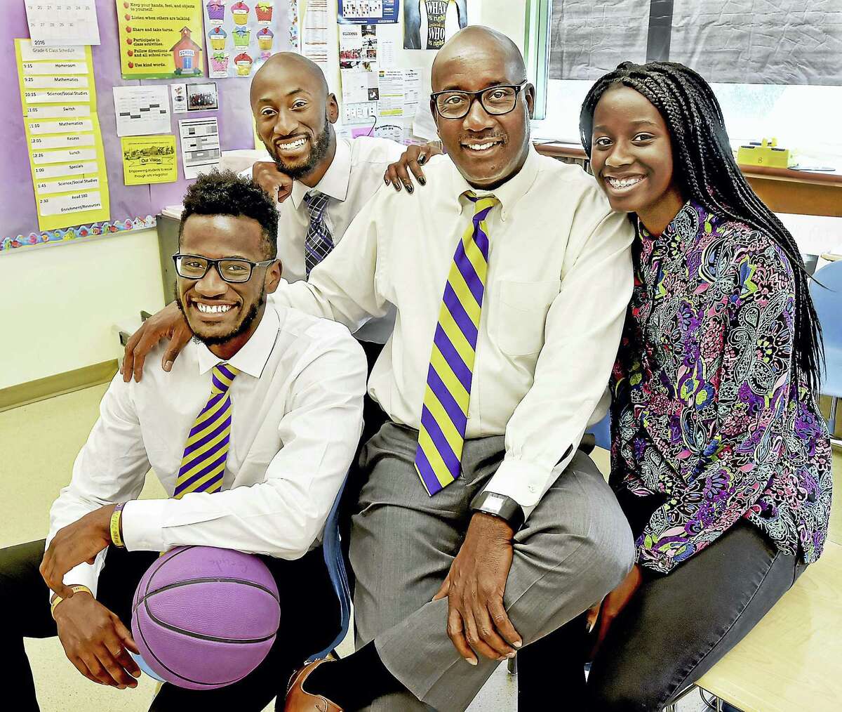 Larry Conaway, 62, the principal at New Light H.S and Riverside Educational Academy in New Haven with his son, Alexander, 23, a Trinsition Fellow and assistant basketball coach at Trinity College, Adham, 26, a teacher at the Davis St. School and Nyka, 15, a rising sophomore at Wilbur Cross, photographed in Adham’s classroom, Tuesday, June 14, 2016.