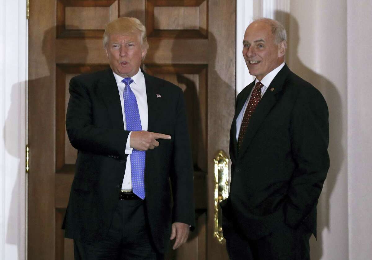 President-elect Donald Trump talks to media as he stands with National Security Adviser-designate, retired Marine Gen. John Kelly at the Trump National Golf Club Bedminster clubhouse in Bedminster, N.J.