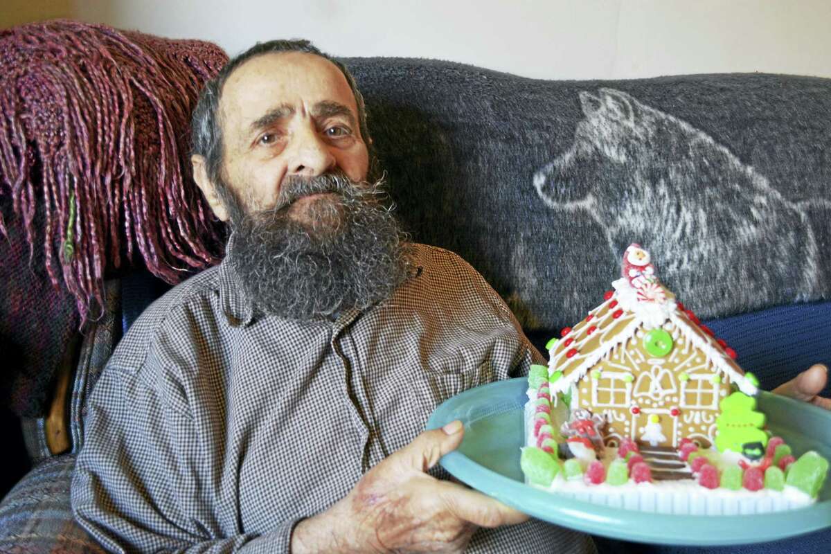 John Lomartra shows off his gingerbread house.