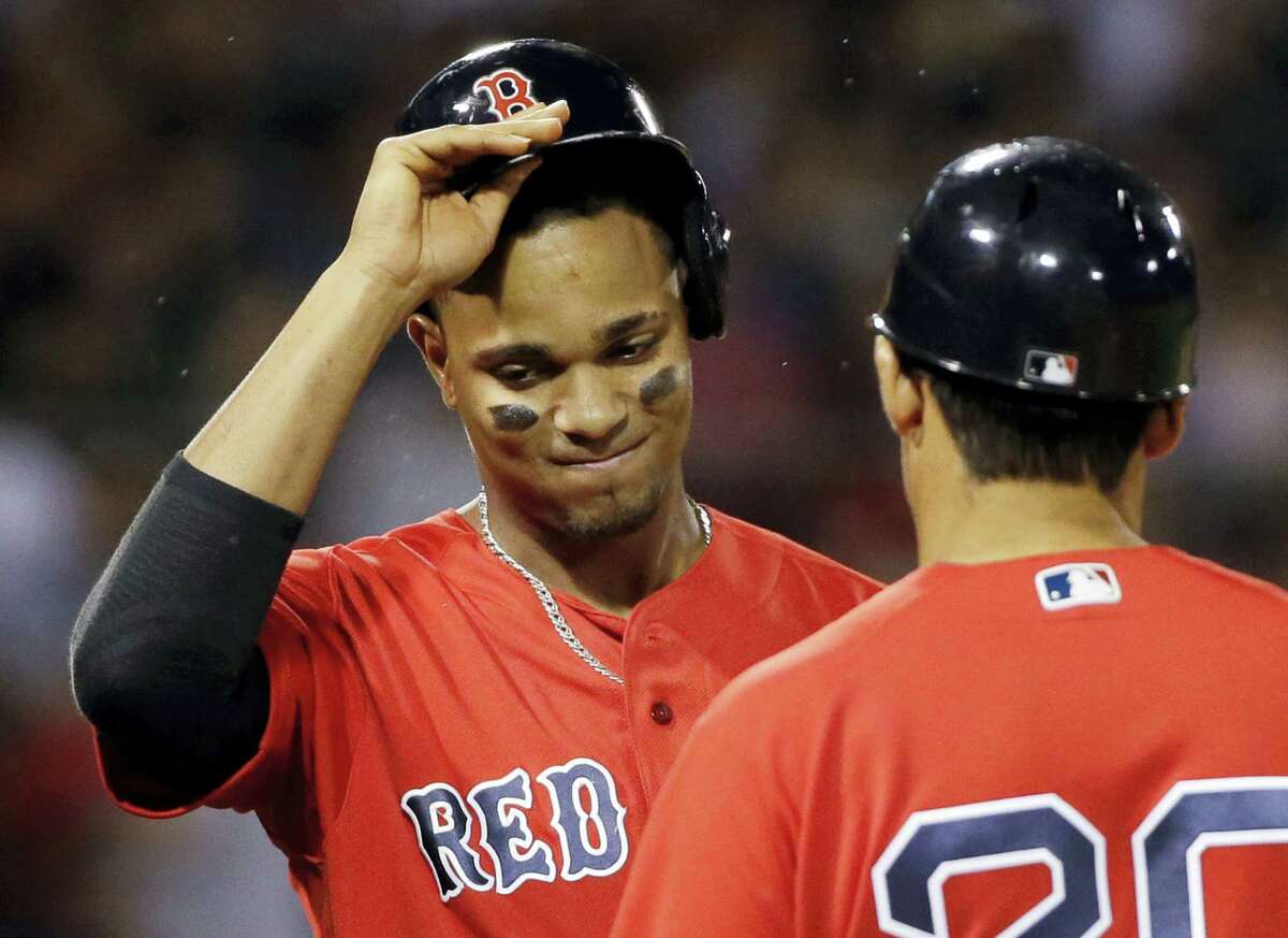 Xander Bogaerts takes his helmet off after popping out to end the seventh inning on Friday.