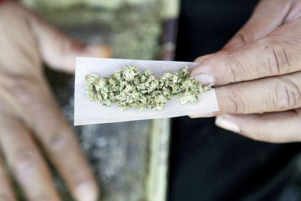 A marijuana joint is rolled in San Francisco. It is now legal in Massachusetts for adults to possess, grow and use limited amounts of recreational marijuana. While the voter-approved law took effect Thursday it will be at least another year before the state issues retail licenses to sell the drug.