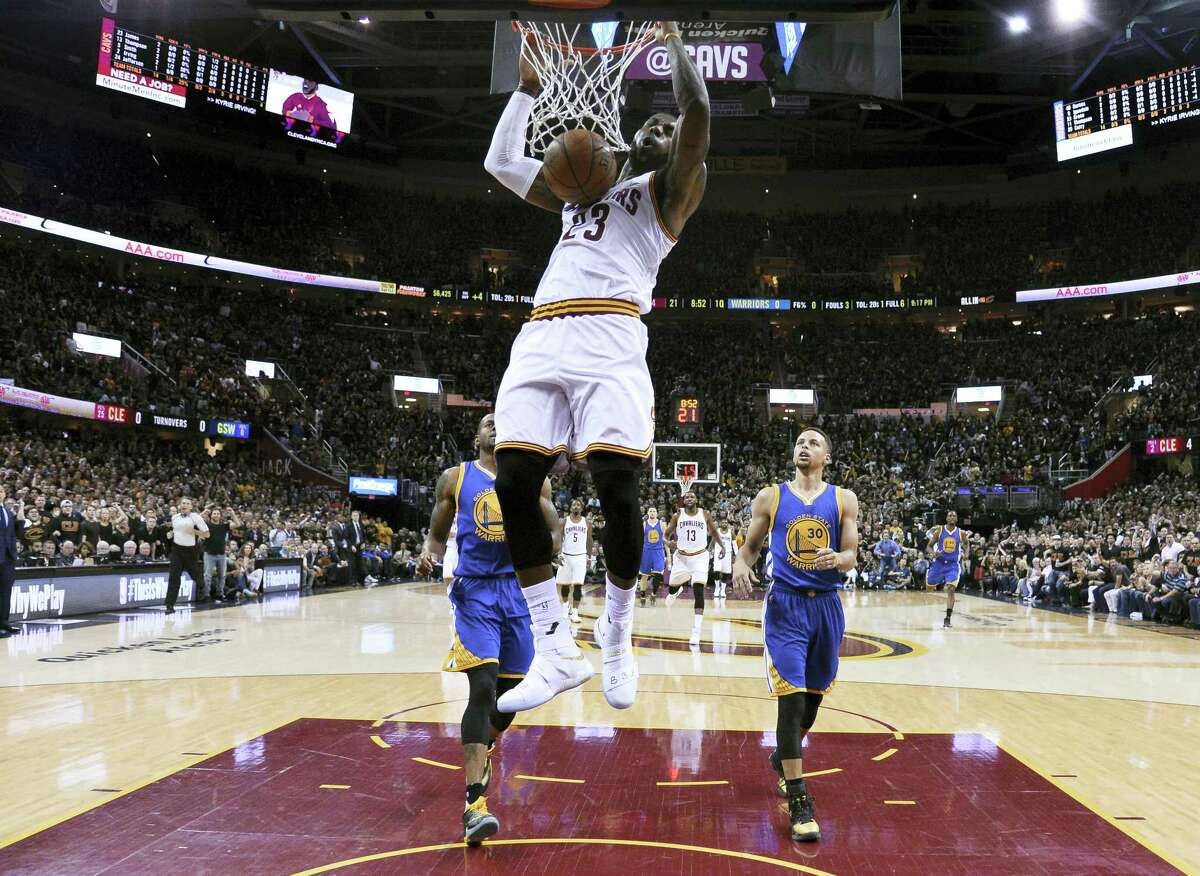 LeBron James dunks during the first half of Game 6 of the NBA Finals in Cleveland on Thursday.
