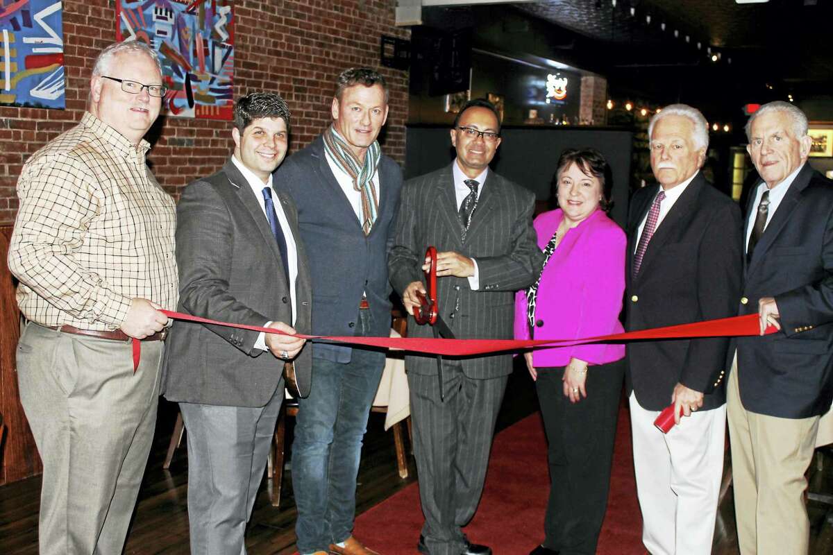 Camp’s at 412 Main St., Middletown, held a grand opening Feb. 3. From left are Chamber Central Business Bureau Chairman Tom Byrne, Mayor Dan Drew, Camp’s co-owner David Kania, co-owner and manager Yaz Sheriff, Diane Gervais of the Downtown Business District, Middletown Small Business Development Center Counselor Paul Dodge, and Chamber President Larry McHugh.