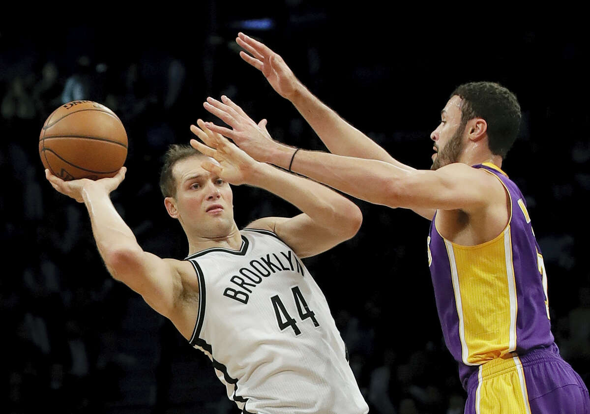 Brooklyn Nets’ Bojan Bogdanovic (44) passes away from Los Angeles Lakers’ Larry Nance Jr. (7) during the second half Wednesday in New York. The Nets won 107-97.
