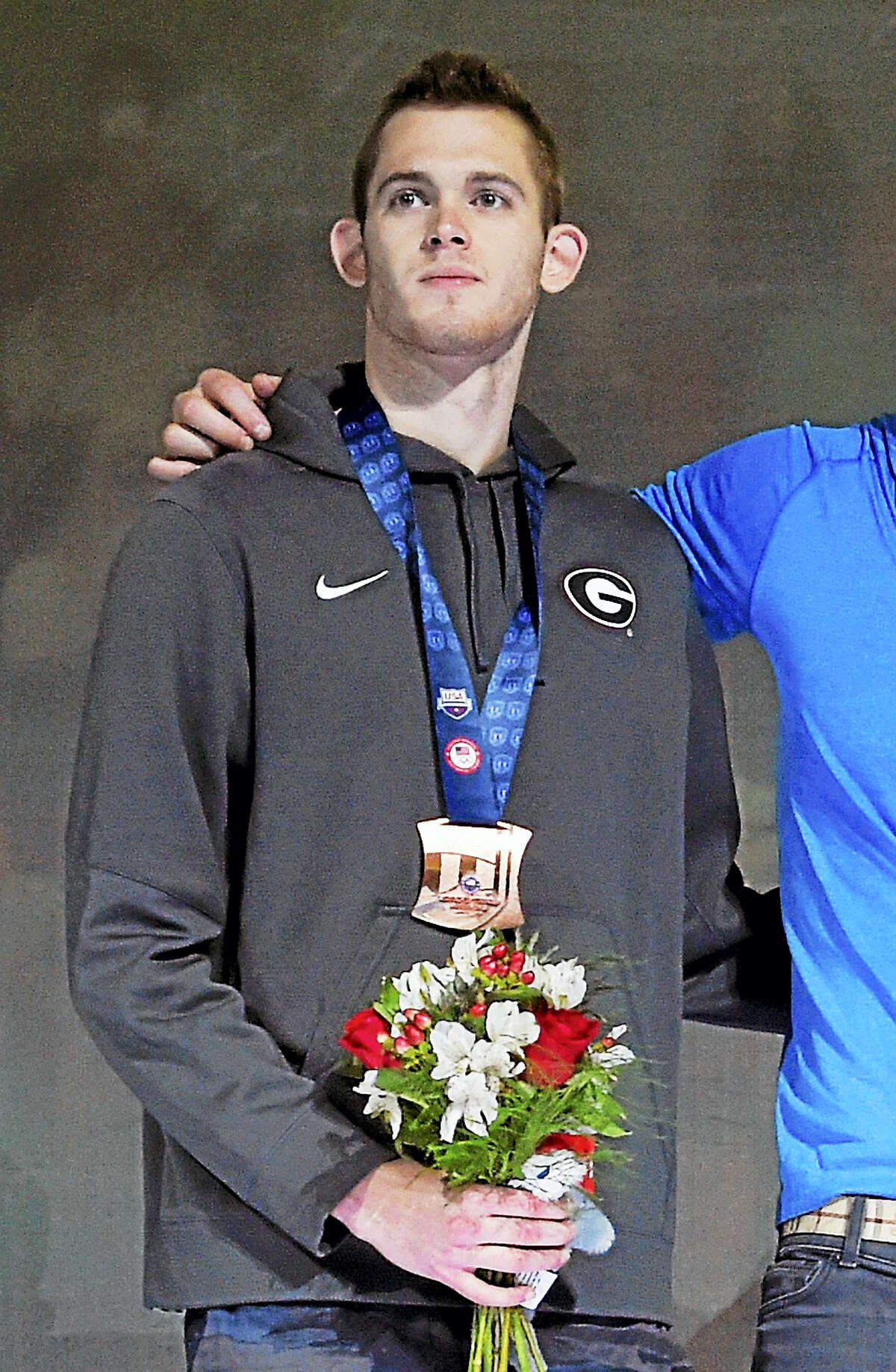 Gunnar Bentz stands with teammates during the men’s 400-meter relay team medal ceremony at the U.S. Olympic swimming trials in Omaha, Neb. The U.S. Olympic Committee said on Wednesday, Aug. 17, 2016 that two American swimmers were taken off their flight from Brazil by local authorities amid an investigation into a reported robbery involving Ryan Lochte and his teammates. USOC spokesman Patrick Sandusky said that “Jack Conger and Gunnar Bentz were removed from their flight to the United States by Brazilian authorities. We are gathering further information.”