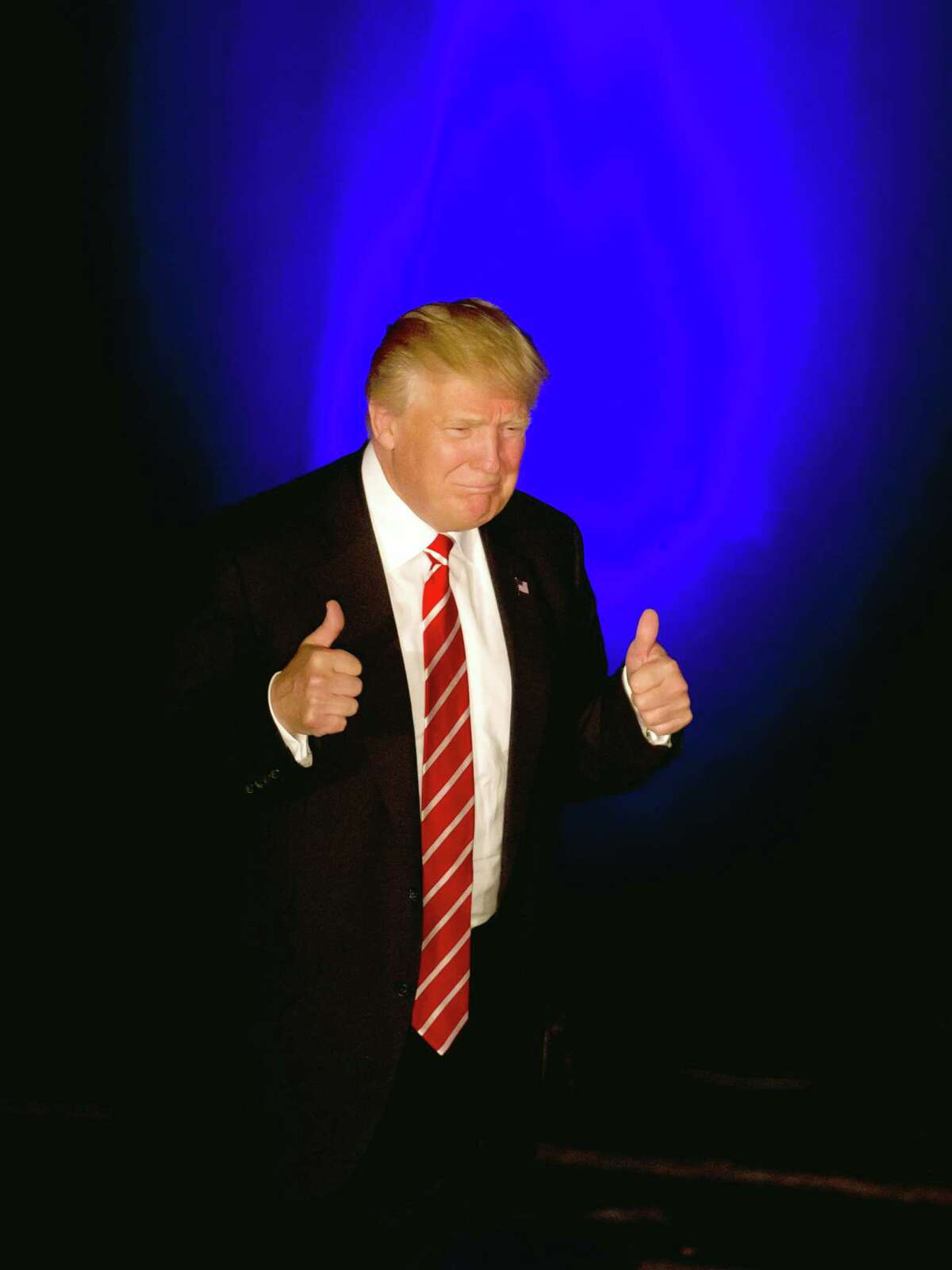Republican presidential candidate Donald Trump gives a thumbs up as he walks on stage to speak at a rally at the Fox Theater Wednesday in Atlanta.
