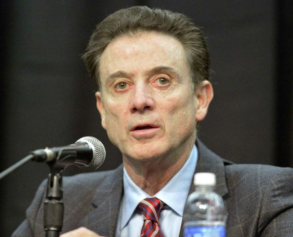 In a Feb. 5, 2016 photo, Louisville head basketball coach Rick Pitino listens to a question during a press conference, in Louisville Ky. The NCAA accuses Louisville of providing impermissible benefits and breaches of conduct as a result of its investigation into an escort’s book allegations that former men’s basketball staffer Andre McGee hired her and other dancers for sex parties with Cardinals recruits and players.