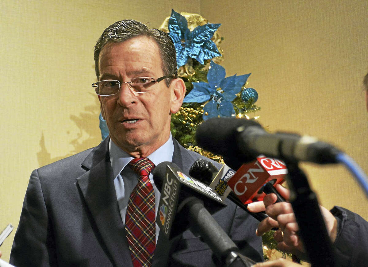 Gov. Dannel P. Malloy speaks to reporters outside the Radisson Hotel conference center Wednesday morning in Cromwell.