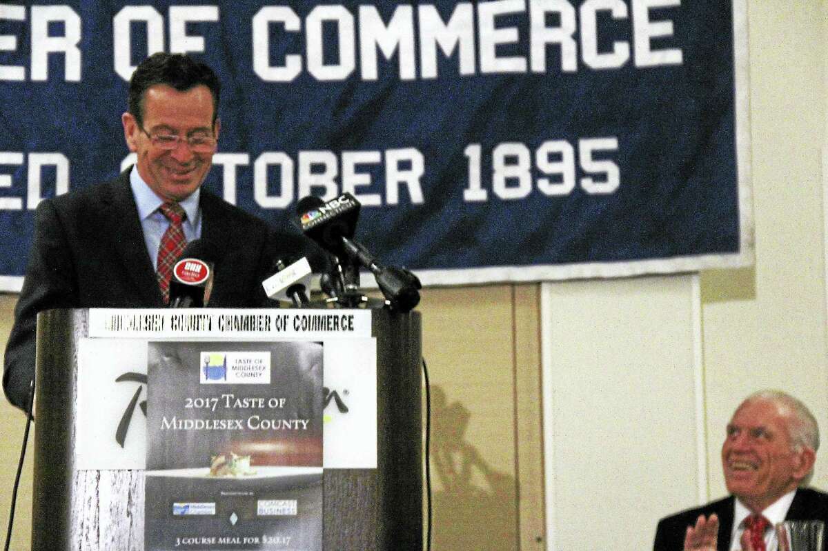 Malloy delivers his annual December keynote address during Wednesday’s Middlesex County Chamber of Commerce member breakfast at the Radisson Hotel in Cromwell. More than 600 business people, officials and others packed the dining room. Chamber President Larry McHugh, right, applauds after the governor’s comments about the state’s progress over the years.
