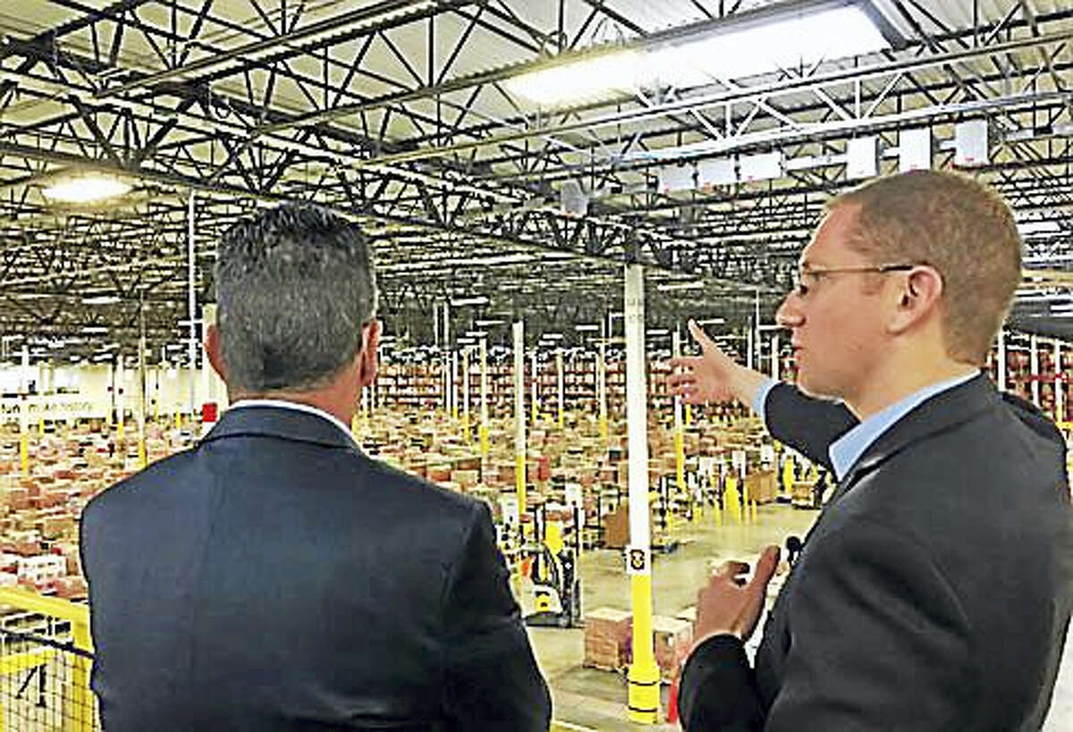 Gov. Dannel P. Malloy gets a tour from Eric Powell, general manager of Windsor’s Amazon facility.