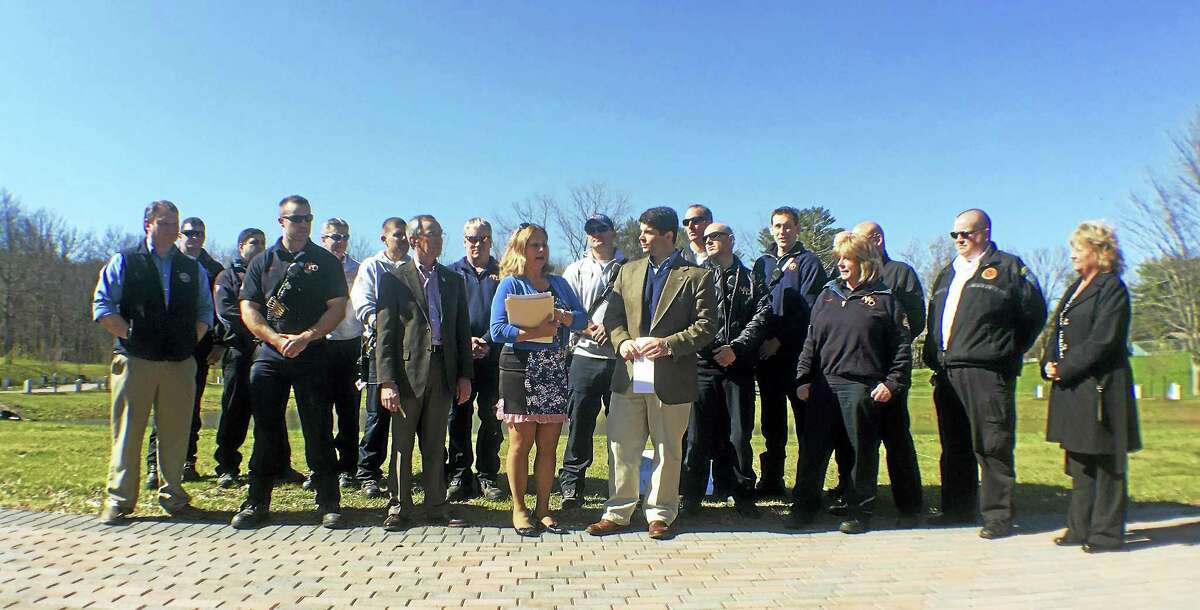 Connecticut Trees of Honor Memorial committee members Roger Beliveau and Sue Martucci join Mayor Daniel Drew, firefighters and other first responders on Wednesday to announce the organization has received some of the last remaining artifacts from the World Trade Center attacks.