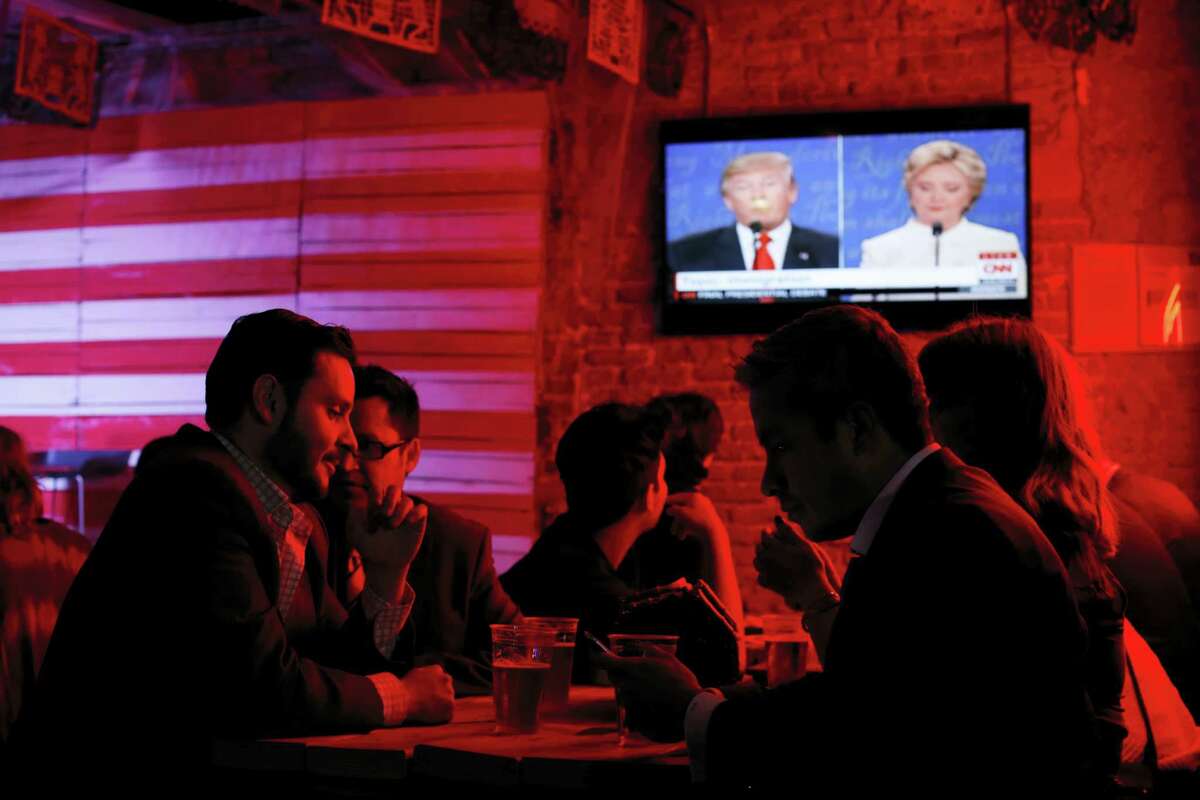 Customers watch the third and last U.S. presidential debate at the Pinche Gringo BBQ restaurant in Mexico City Wednesday.