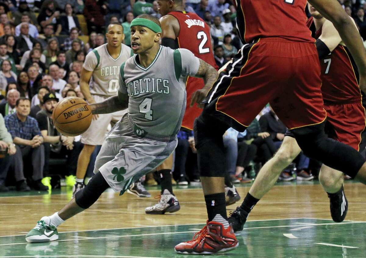 Celtics guard Isaiah Thomas (4) drives against the Miami Heat defense on Wednesday.