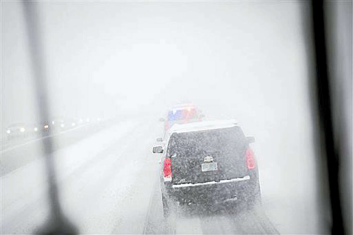 The motorcade of Democratic presidential candidate Sen. Bernie Sanders, I-Vt., drives through a snow storm on Interstate 93, Friday, Feb. 5, 2016, in Manchester, N.H. What started off as rain Friday morning quickly turned to sticky, heavy snow. Many school districts in the region closed for the day, including in some in Massachusetts, New Hampshire and Rhode Island.