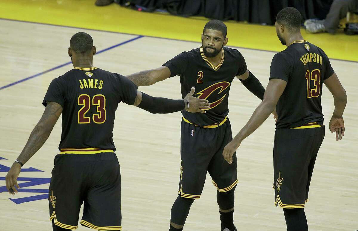 Cavaliers guard Kyrie Irving, center, forward LeBron James, left, and center Tristan Thompson react during the second half of Game 5 of the NBA Finals on Monday.
